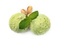 Scoops of delicious pistachio ice cream with mint and nuts on white background Royalty Free Stock Photo