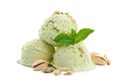 Scoops of delicious pistachio ice cream with mint and nuts on white Royalty Free Stock Photo
