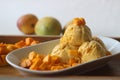 Scoops of Home made mango ice cream served with fresh cut Lalbagh mangoes Royalty Free Stock Photo