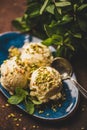 Scoops of Turkish dessert semolina helva with pistachio and mint