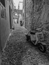 Greek Rhodes old town motorbike scooter alleyway. Black and white.