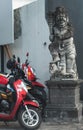 Scooter bikes parked next to a balinese statue