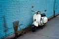 Scooter on a blue wall. Royalty Free Stock Photo