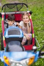 Scooter with little girl and boy in cart on Royalty Free Stock Photo