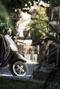 Scooter motorbike on city street. Stylish picture of urban life with motorcycle immersed in greenery of city park Royalty Free Stock Photo