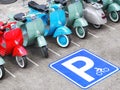 Scooter and motorcycle parking sign and row of mopeds