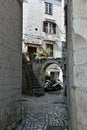 A Scooter Parked Under a Stone Arch in a Narrow Alley in Old Town Trogir, Croatia Royalty Free Stock Photo