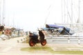 Scooter stands on the dock on the background of sailing cruise yachts in the Mediterranean marina. Popular transport of yachtsmen