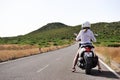 Madeira, Portugal. August 12, 2019: scooter Yamaha NMAX 125.Girl explore the terrain in the cloudy mountains of Madeira.Girl in s