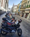 Scooters and motorcycles parked on the street.