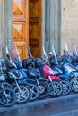 Scooters parked in the street at an open door