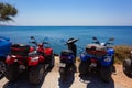 Scooters and quads parked by the sea in Santorini island.