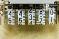 Scoreboard mechanism on scratched industrial brass metal plate