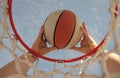 scoring during basketball game. ball goes through basket. man throwing the ball in hoop Royalty Free Stock Photo