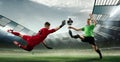 Scoring moment. Football goalkeeper in gates jumping to catching flying ball during soccer match at evening stadium Royalty Free Stock Photo