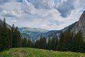 Scorota sheepfold in Retezat mountain with peak forest blue sky Royalty Free Stock Photo