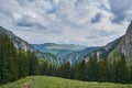 Scorota sheepfold in Retezat mountain with peak forest blue sky Royalty Free Stock Photo