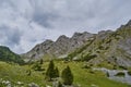 Scorota sheepfold in Retezat mountain with peak forest blue sky Royalty Free Stock Photo