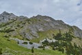 Scorota sheepfold in Retezat mountain with peak forest blue sky Royalty Free Stock Photo