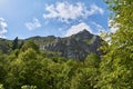 Scorota sheepfold in Retezat mountain with peak forest blue sky Royalty Free Stock Photo