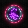 Scorpio glowing neon sign in circle frames on dark brick wall background. Royalty Free Stock Photo