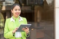 Scort woman with tablet and mobile phone smiling