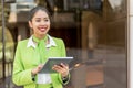 Scort woman with tablet and mobile phone smiling