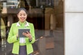 Scort crew with tablet smiling green jacket