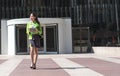 Scort woman with tablet and mobile phone smiling