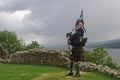 Scot plays bagpipes in front of Loch Ness