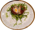 scotch egg cut in half on a plate served with a leafy salad Royalty Free Stock Photo