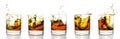 Scotch glasses with whiskey splashing from them Royalty Free Stock Photo