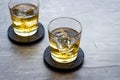 Scotch - two glasses with ice - on grey stone background copy space