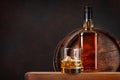 Scotch whiskey bottle, glass and old barrel Royalty Free Stock Photo