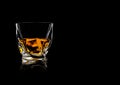 Scotch whiskey in crystal modern luxury glass on black background with reflection Royalty Free Stock Photo