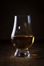 Scotch Whiskey without ice in glass, rustic wood background, copy space