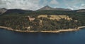 Scotland Brodick ocean bay aerial view: alone sailboat at Firth-of-Clyde Gulf water. Scottish nature