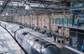 Edinburg central train station. Interior of station with escalators and people waiting boarding Royalty Free Stock Photo