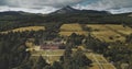 Scotland landscape aerial shot: mountains Goatfell, ancient Brodick Castle. Scottish landmarks Royalty Free Stock Photo