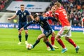 Scotland national football team winger Oliver Burke against Russia players Andrey Semenov and Dmitri Barinov