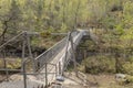 Suspended metal bridge crossing a ravine Royalty Free Stock Photo