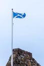 Scotlands Saltire Flag Flying High on Top of One of Scotlands Historic Castles in Seamill Scotland Royalty Free Stock Photo