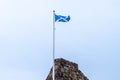 Scotlands Saltire Flag Flying High on Top of One of Scotlands Historic Castles in Seamill Scotland Royalty Free Stock Photo