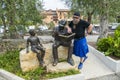 Scotsman in kilt reading the book of the bronze statue, in Torri del Benaco Royalty Free Stock Photo