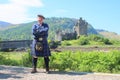 Scotsman in kilt and historical castle