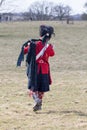 Scotsman piper marching to reenactment battle