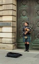 a Scotsman in a traditional kilt plays the bagpipes in the tourist town center Royalty Free Stock Photo