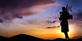 Scottish bagpiper at sunset Royalty Free Stock Photo