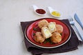 Scottish eggs, boiled quail eggs in minced chicken on a red clay plate on a light concrete background. Can be served as a starter