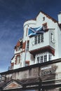 Scottish flag over the Royal Mile name sign, Edinburgh, Scotland